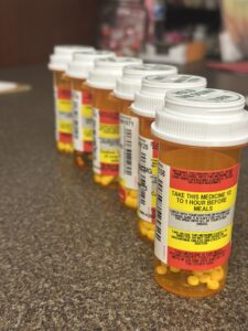 Prescription medication bottles with clear pharmaceutical labels for dosage and safety instructions