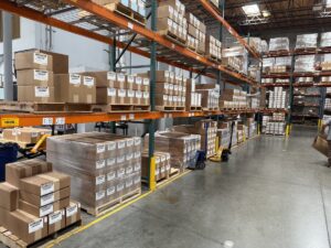 Warehouse shelving with stacked pallets and labeled boxes in an organized industrial storage area